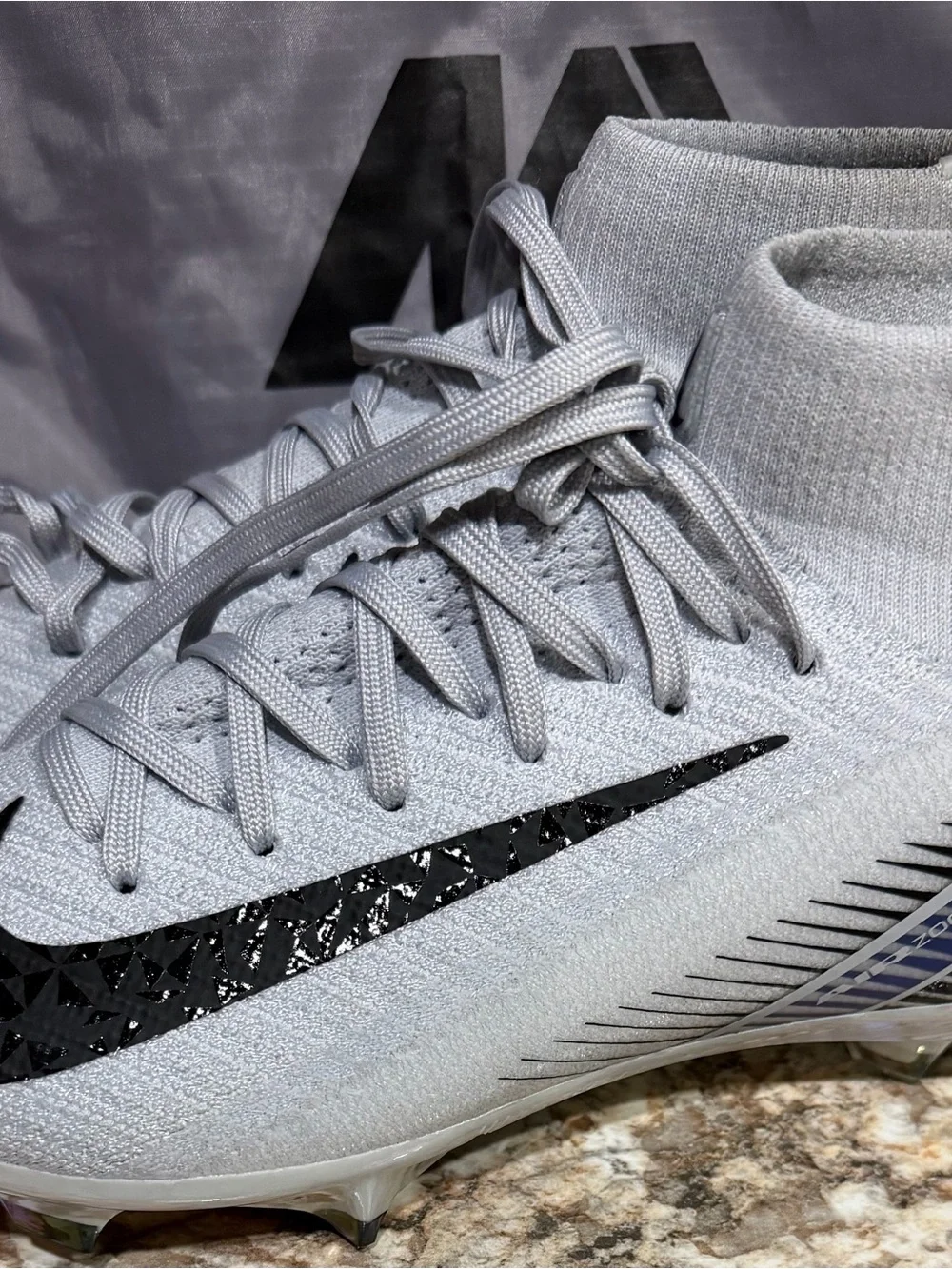 Nike Men’s Light Gray High-Top Soccer Cleats with Black Swoosh